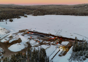 A bird's eye view of a dam construction site in winter.